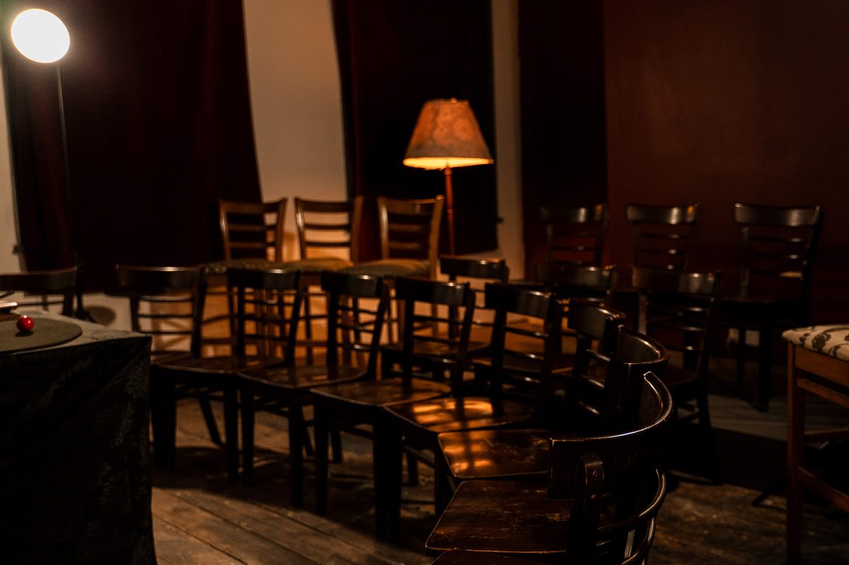 The intimate interior of The Lost Dice venue at 111 King William St Adelaide, set up for a magic show with warm lighting and close seating